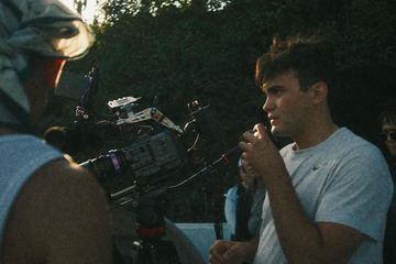 Javi in profile behind the camera at dusk