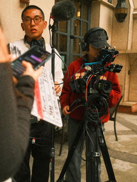 The slate held up beside the camera in a courtyard