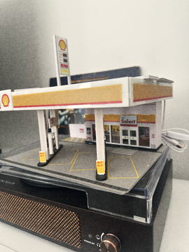 The miniature gas station built for the film, photographed on a turntable