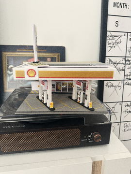 The miniature gas station beside the production calendar