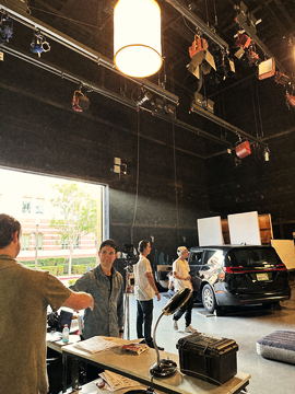 Crew at the production table by the open stage door