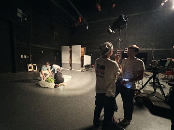 Camera crew watching the bedding prop being dressed