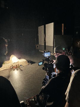 Camera monitor glowing in the dark as the lit prop is filmed