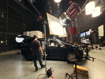 The picture car on stage with a monitor playing the background plate
