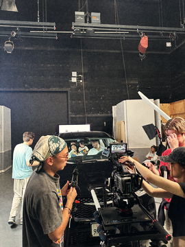 Camera mounted at the front of the picture car with the crew around it