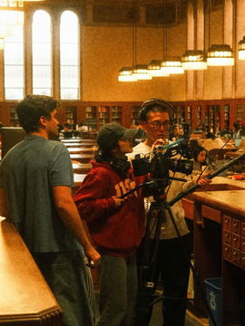 Crew filming in the reading room of a library