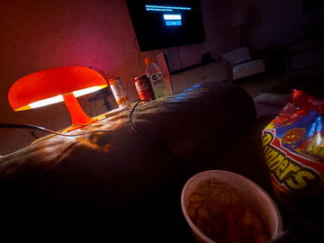 A red mushroom lamp glowing in a dark room